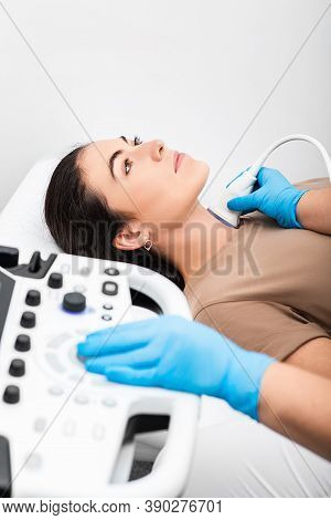 Ultrasound Diagnostics Of The Endocrine System And Thyroid For Woman. A Female Patient Receives Thyr