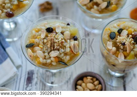 Traditional Turkish Dessert Asure Or Ashura ( Noah Pudding) Making From The Boiled Cereals With Drie