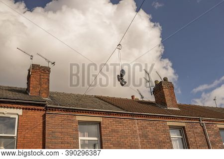Hexthorpe, Doncaster, England - October 7, 2020.  Old Sneakers Hanging From An Electricity Wire Agai