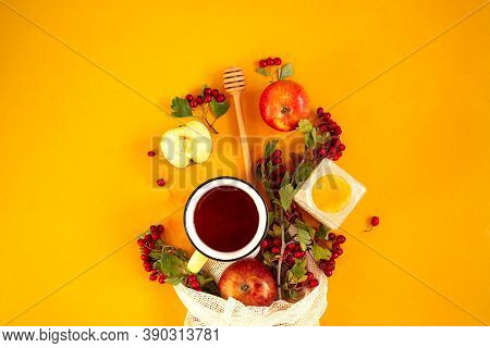 Red Garden Organic Apples, Hawthorn Berries In A Mesh Bag And Cup Of Hot Tea On An Orange Background