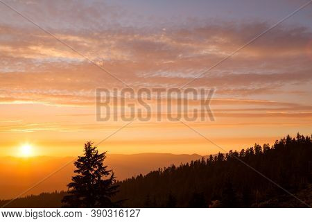 Thick Layers Of Smoke From A Nearby Forest Fire Turn The Suns Rays A Glowing Orange As It Sets Over 
