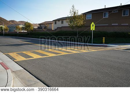 Low Angle View Of Crosswalk And School Crosswalk Sign