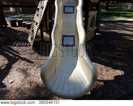 Metal Rollers On Plastic Playground Slide At Park