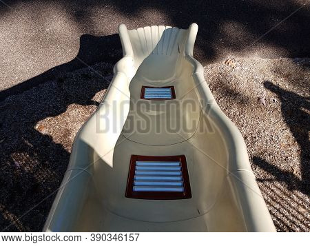 Metal Rollers On Plastic Playground Slide At Park