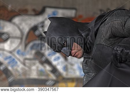 Umea, Norrland Sweden - September 5, 2020: Cosplayer Dressed As Batman With Graffiti In The Backgrou