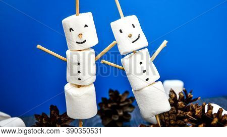 Two Happy Funny Marshmallow Snowmen. Marshmallow Friends On Blue Background. Diy. Sweet Treat For Ki