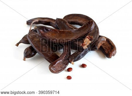Dry Carob Pods And Seeds Close Up Isolated On White