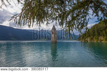 The Bell Tower Of The Sunken Church In Curon, Resia Lake, Bolzano Province, South Tyrol, Italy.