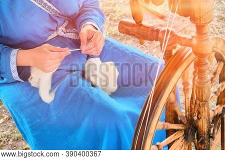 Spinning Wheel Is A Device For Manual Spinning Of One Yarn Thread. The Spinner - Woman, Engaged In H
