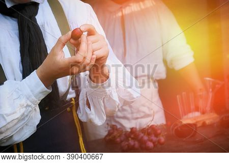 Winemaker Shows How To Create Wine From Grapes. Viniculture In France. A Man Holds A Large Grape In 