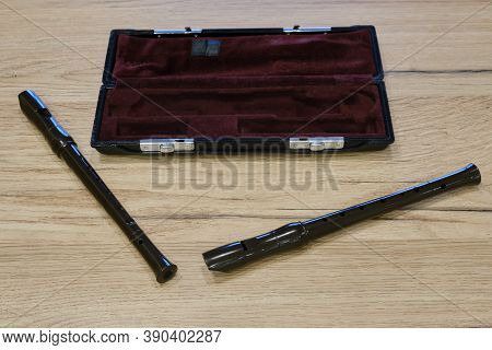 Recorders Flutes On A Wooden Table With A Red Case, Closeup, Textured