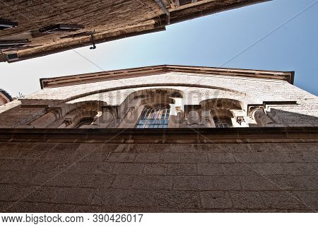 An Upward View Of The Gables Of Two Stone Buildings Opposite Each Other And Forming A Narrow Corrido