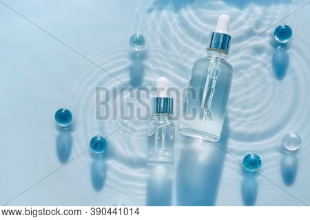 Cosmetic Spa Medical Skin Care, Bottle For Serum, Micellar Toner And Emulsion On Water Texture Backg