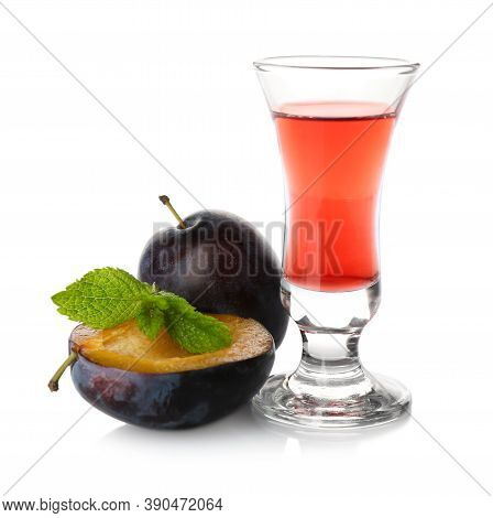 Delicious Plum Liquor, Ripe Fruits And Mint On White Background. Homemade Strong Alcoholic Beverage