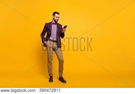 Full Length Photo Of Handsome Rich Clothes Stylish Guy Well-dressed Business Man Browsing Telephone 