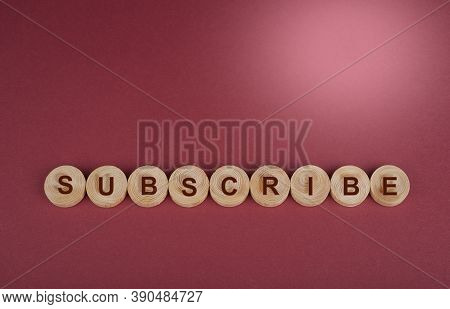 Subscribe Sign On A Wooden Circles On A Red
