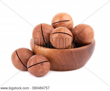 Macadamia Nuts In Wooden Bowl, Isolated On White Background. Unshelled Macadamia.