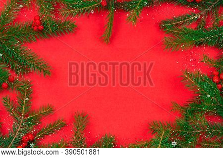 Christmas Tree Branches With Red Rowan Berries, Baka, Snow With Copy Space In The Center On A Red Ba