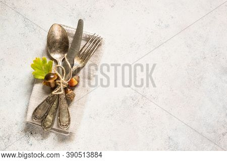 Fall Table Setting With Silverware And Fall Decorations At White Table. Top View With Copy Space.
