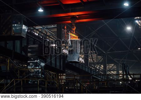 Iron Casting At The Foundry. Overhead Crane With Ladle With Molten Metal At Metallurgical Factory