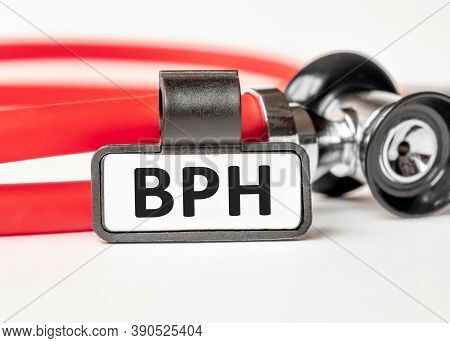 Bph Benign Prostatic Hyperplasia Lettering On A Business Card With A Holder, Next To The Red Stethos