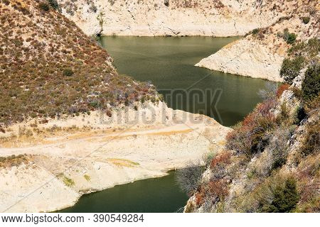Low Laying Water Levels Caused From A Prolonged Drought Taken At A Reservoir Besides The Big Tujunga