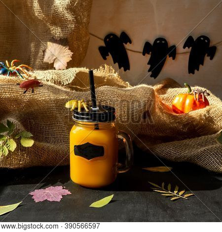 Orange Halloween Mococktail And Holiday Decor On A Dark Mystical Autumn Background. Chosts On Backgr