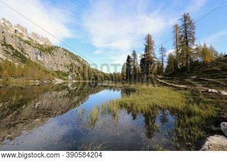 Autumn In The Dolomites, View Of Federa Lake Surrounded By Mountains. High Quality Photo