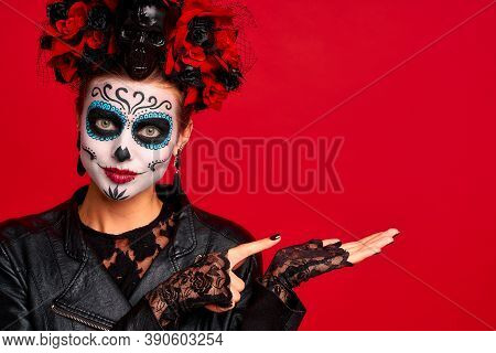 Young Woman With Sugar Skull Makeup With A Wreath Of Flowers On Her Head And Skull And Black Gloves 