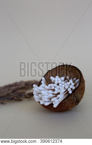 Cotton Ear Swabs With Wooden Base In A Coconut Cup. Zero Waste Concept