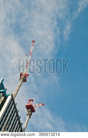 Underconstruction Building In Progress With Many Construction Cranes And Bright Sunny Blue Sky With 
