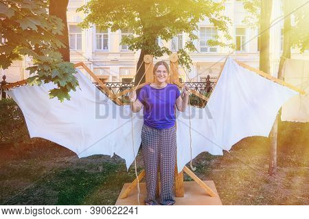 Wings Of Leonardo Da Vinci, The Idea Of The Italian Inventor. A Young Woman With The Mechanism Of Th
