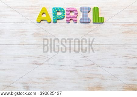 Wooden Letters Written April Month On Vintage Background. Inscription April With Copy Space. Top Vie