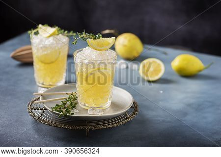 Cocktail With Lemon, Timo And Crushed Ice
