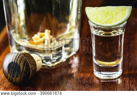 Glass And Bottle With Mezcal (or Mescal) Is Commonly Known As Tequila With Larvae Or Worm, An Exotic