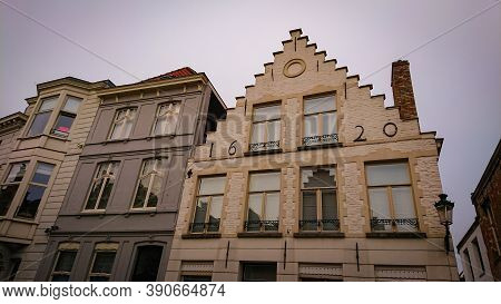Bruges, Belgium - May 12, 2018:  Roofs And Windows Of Old Authentic Brick Houses On Street Sint-jako