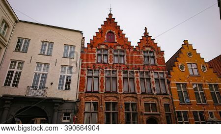 Bruges, Belgium - May 12, 2018:  Roofs And Windows Of Old Authentic Brick Houses On Street Sint-jako