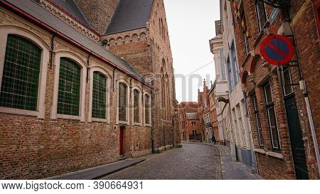 Bruges, Belgium - May 12, 2018:  Roofs And Windows Of Old Authentic Brick Houses On Street Sint-jako