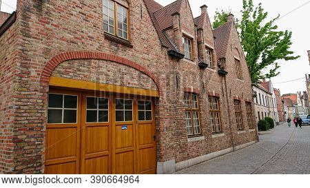 Bruges, Belgium - May 12, 2018:  Roofs And Windows Of Old Authentic Brick Houses On Street Ontvanger