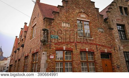 Bruges, Belgium - May 12, 2018:  Roofs And Windows Of Old Authentic Brick Houses On Street Ontvanger