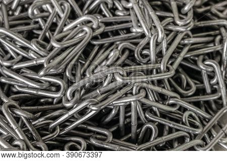 Close-up Of Long Industrial Steel Chain. Heap Of Chains.