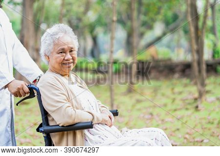 Doctor Help And Care Asian Senior Or Elderly Old Lady Woman Patient Sitting On Wheelchair At Park In