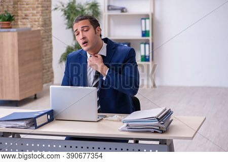 Sick male employee suffering at workplace