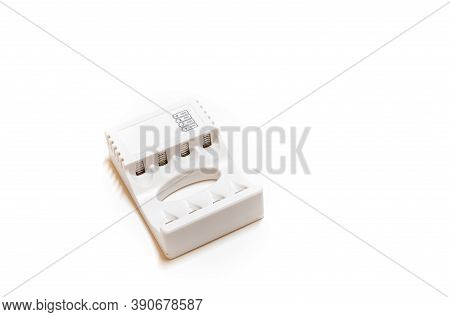 White Charger For Batteries On A White Background