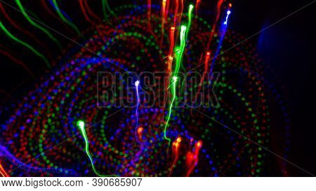 Colored Lights Go Up. Beaded Christmas Garland In The Dark.