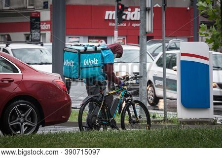 Belgrade, Serbia - May 2, 2020: Wolt Logo On The Bag Of A Delivery Man On His Bicycle. In Belgrade. 