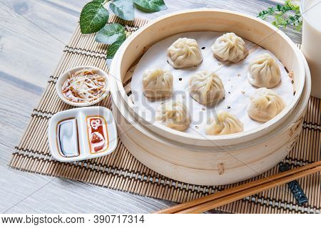 Steamed Xiaolongbao Served In A Traditional Steaming Basket