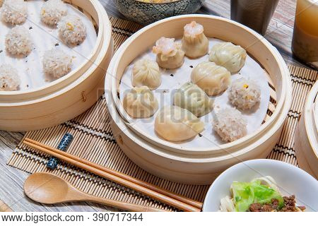 Steamed Xiaolongbao And Steamed Dumplings Served In A Traditional Steaming Basket (.close Up)