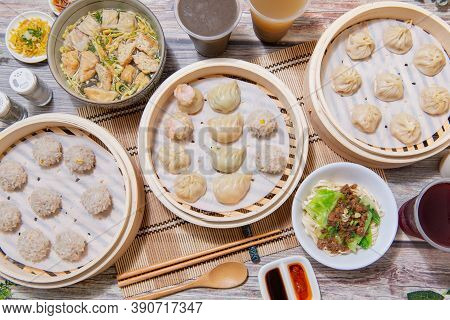 Steamed Xiaolongbao And Steamed Dumplings Served In A Traditional Steaming Basket
