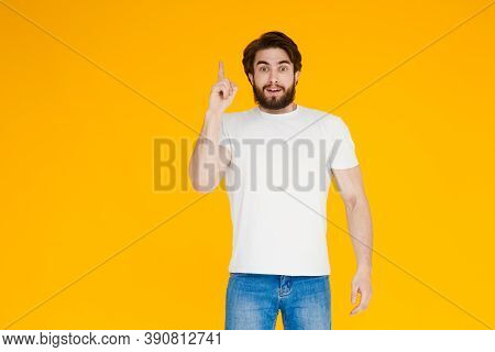 Young Handsome Man With Beardwhite Shirt Standing Over Yellow Background Pointing Finger Up With Suc